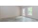 Large room featuring a concrete floor, a window and a glass paneled door at 4106 Creekview Ridge Ne Dr, Buford, GA 30518