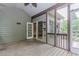 Outdoor screened porch with wood flooring, a ceiling fan, and offering private wooded views at 4106 Creekview Ridge Ne Dr, Buford, GA 30518