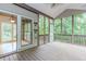 Inviting screened porch with wood floors, scenic views, and convenient access to the home's interior at 4106 Creekview Ridge Ne Dr, Buford, GA 30518