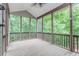 Relaxing screened porch with wood flooring, natural light, and views of surrounding greenery at 4106 Creekview Ridge Ne Dr, Buford, GA 30518