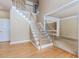 Elegant foyer with hardwood floors, a staircase with carpeted steps, and an open doorway to a carpeted living room at 4106 Creekview Ridge Ne Dr, Buford, GA 30518
