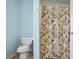Cozy bathroom showcasing a patterned shower curtain next to a toilet with light blue walls at 45 Hunters Ridge Ct, Covington, GA 30014