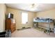 This bedroom features a bunk bed, window, ceiling fan and a dresser for storage at 45 Hunters Ridge Ct, Covington, GA 30014