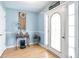 Bright entryway with hardwood floors and a decorative front door and a sign with 