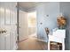 Hallway with neutral carpet and a writing desk with a floral arrangement at 45 Hunters Ridge Ct, Covington, GA 30014
