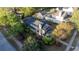 Stunning aerial view of a home showcasing mature trees, lush landscaping, and a well-manicured lawn at 498 Trip St, Grayson, GA 30017