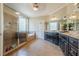 Bright bathroom featuring a glass shower, soaking tub, and a double sink vanity with ample counter space at 498 Trip St, Grayson, GA 30017