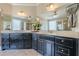Large bathroom with double sinks, dark cabinets, and large mirrors above vanity at 498 Trip St, Grayson, GA 30017