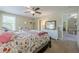 Bright bedroom with floral bedding, white dresser, carpet floor and bright natural light coming in the windows at 498 Trip St, Grayson, GA 30017