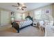 Cozy bedroom featuring a ceiling fan, carpet floors, a comfortable bed, and a unique egg-shaped chair at 498 Trip St, Grayson, GA 30017