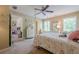 Bright carpeted bedroom featuring a four-poster bed and lots of natural light from the windows at 498 Trip St, Grayson, GA 30017