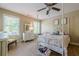 Bright, carpeted bedroom with four-poster bed, dresser, and ample natural light from the windows at 498 Trip St, Grayson, GA 30017