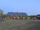 Charming brick commercial building with a black metal roof and manicured landscaping at 498 Trip St, Grayson, GA 30017