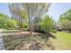 Serene home exterior with lush lawn and mature trees, enhanced by classic American flag display at 498 Trip St, Grayson, GA 30017