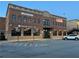 Street view of a brick building featuring businesses and event space at 498 Trip St, Grayson, GA 30017