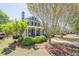 Charming two-story house with a welcoming front porch, surrounded by lush greenery and mature trees at 498 Trip St, Grayson, GA 30017