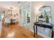 Spacious foyer with hardwood floors, decorative mirror, and a glimpse into the formal dining room at 498 Trip St, Grayson, GA 30017
