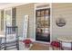 Charming front door with sidelights, decorative wreath, and cozy rocking chair at 498 Trip St, Grayson, GA 30017