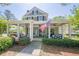 Inviting two-story home with a wide front porch, ceiling fans, and cozy porch swings at 498 Trip St, Grayson, GA 30017