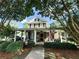 Charming two-story home features a welcoming front porch with stylish seating and an American flag at 498 Trip St, Grayson, GA 30017