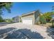 Detached garage with a connecting driveway, surrounded by lush landscaping and a well-kept lawn at 498 Trip St, Grayson, GA 30017