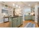 Kitchen featuring sage cabinets, granite countertops, stainless appliances, and a stylish central island at 498 Trip St, Grayson, GA 30017