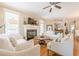 Inviting living room with a fireplace, hardwood floors, and ample natural light at 498 Trip St, Grayson, GA 30017