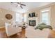 Bright and airy living room featuring a fireplace, ceiling fan, and neutral decor at 498 Trip St, Grayson, GA 30017