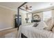 A serene main bedroom featuring a four-poster bed, dresser, and large windows with natural light at 498 Trip St, Grayson, GA 30017