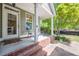 Charming covered porch with brick base, offering a cozy outdoor space to enjoy the front yard view at 498 Trip St, Grayson, GA 30017