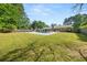 Large backyard with an in-ground pool, covered patio, and ample green space at 3127 Hidden Forest Dr, Snellville, GA 30078
