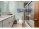 Clean bathroom with a walk-in shower, updated tiling and new, modern fixtures throughout at 3127 Hidden Forest Dr, Snellville, GA 30078