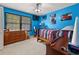 Bright blue bedroom with natural light and a ceiling fan; ideal for a or guest at 3127 Hidden Forest Dr, Snellville, GA 30078