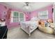 Vibrant pink bedroom with natural light, perfect for a young or teenager at 3127 Hidden Forest Dr, Snellville, GA 30078