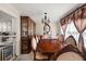 Elegant dining room with a beautiful wood table, decorative china cabinet, and charming accents for Gathering gatherings at 3127 Hidden Forest Dr, Snellville, GA 30078