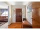 Charming entryway with hardwood floors, stylish wallpaper, and a wooden front door at 3127 Hidden Forest Dr, Snellville, GA 30078
