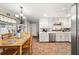 Bright kitchen boasts white cabinets, modern appliances, and an adjacent dining area, perfect for culinary enthusiasts at 3127 Hidden Forest Dr, Snellville, GA 30078