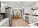 Inviting kitchen with white cabinets, stainless steel appliances, and a dining area, perfect for cooking and entertaining at 3127 Hidden Forest Dr, Snellville, GA 30078