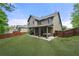 Spacious backyard with manicured lawn, a covered patio, hot tub, and a private fenced perimeter at 3599 Bellmonte Dr, Atlanta, GA 30337