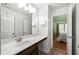 Bright bathroom featuring a sink with countertop space, large mirror, and access to the bedroom at 3599 Bellmonte Dr, Atlanta, GA 30337
