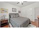 Well-lit bedroom featuring a stylish geometric patterned comforter and hardwood flooring at 3599 Bellmonte Dr, Atlanta, GA 30337