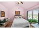 Inviting bedroom featuring a comfortable bed, side table, and sunny window with a view of the outdoors at 3599 Bellmonte Dr, Atlanta, GA 30337