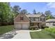Charming two-story brick home featuring a two-car garage and well-manicured landscaping at 3599 Bellmonte Dr, Atlanta, GA 30337