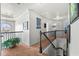 Upstairs hallway with iron railings, carpeted floor, and natural light from a window at 3599 Bellmonte Dr, Atlanta, GA 30337
