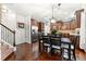 Open kitchen with dark wood cabinets, stainless steel appliances, and an adjacent dining area at 3599 Bellmonte Dr, Atlanta, GA 30337