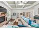 Comfortable living room with a stone fireplace, large sectional, and a tray ceiling at 3599 Bellmonte Dr, Atlanta, GA 30337