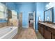 Main bathroom featuring a soaking tub, separate shower, and double sink vanity at 3599 Bellmonte Dr, Atlanta, GA 30337