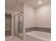 Bathroom features a shower with glass door, large tub with mosaic tile backsplash at 518 Scenic Pass, Woodstock, GA 30189