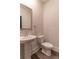 Modern bathroom with pedestal sink, toilet, and attractive wood-look flooring at 518 Scenic Pass, Woodstock, GA 30189