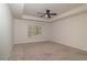 This bedroom features neutral carpet, a window with blinds, and a ceiling fan at 518 Scenic Pass, Woodstock, GA 30189